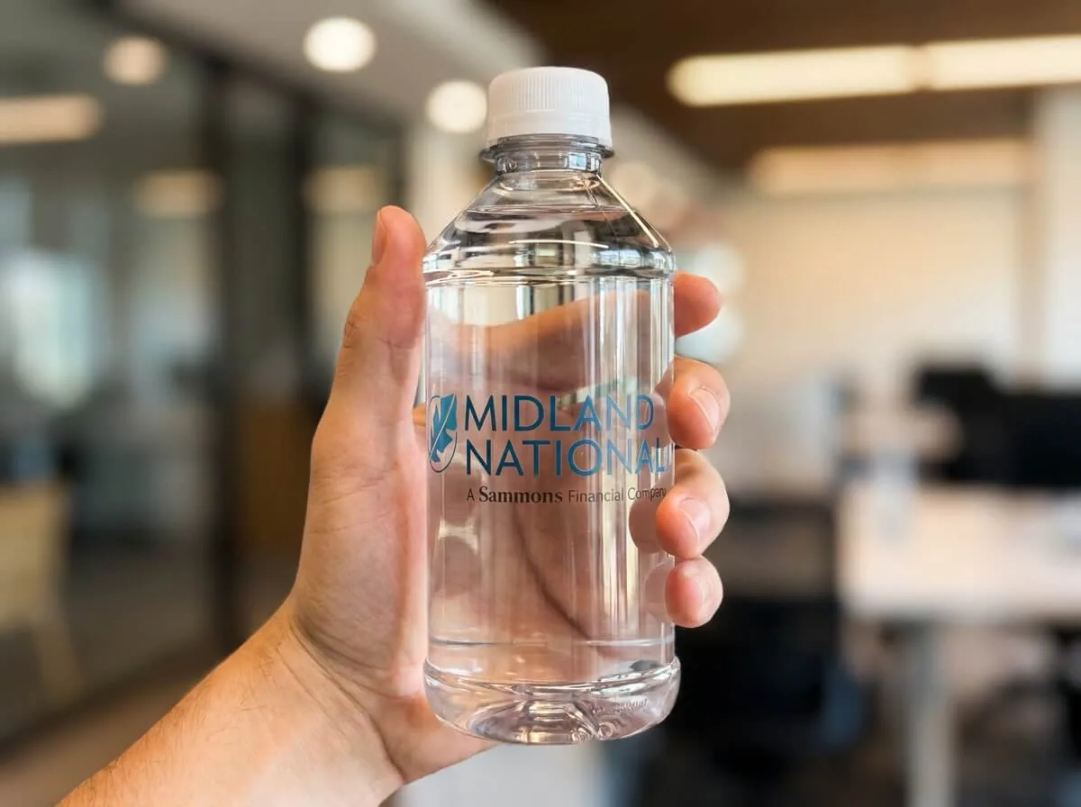 Custom-label water bottle held in hand